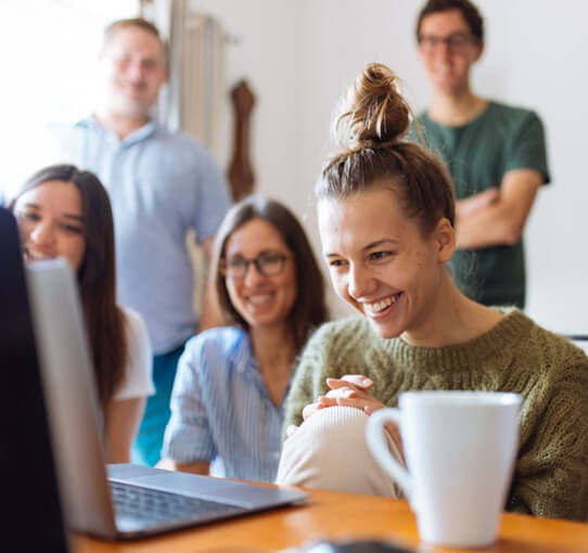 Group sitting in front of computer